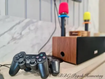 a video game controller sitting next to a wooden box at BBC Pegoh in Ipoh