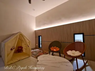 a room with two chairs and a play house at BBC Pegoh in Ipoh