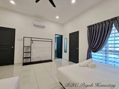 a bedroom with a bed and a large window at BBC Pegoh in Ipoh