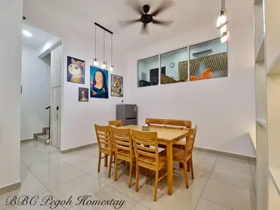 a dining room with a wooden table and chairs at BBC Pegoh in Ipoh