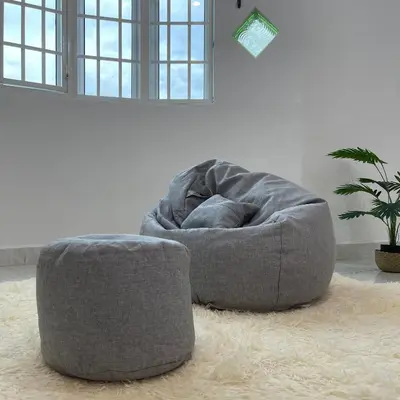a grey bean bag chair sitting on a rug in a room at Cozyhaus Ipoh in Ipoh