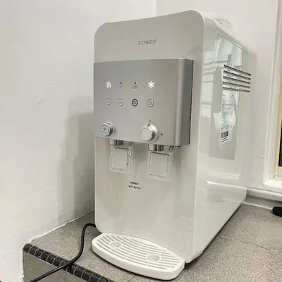 a white coffee machine sitting on the floor at Cozyhaus Ipoh in Ipoh