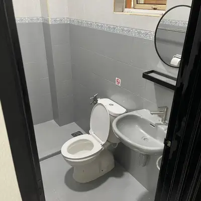 a bathroom with a toilet and a sink at Cozyhaus Ipoh in Ipoh