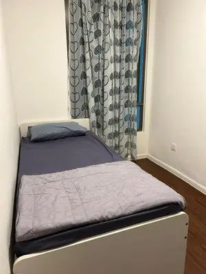 a small bed in a room with a window at Ella Residence Homestay in Brinchang