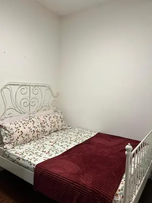 a bedroom with a white bed with a red blanket at Ella Residence Homestay in Brinchang