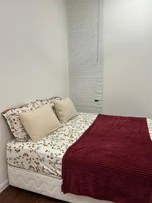a bed with two pillows and a blanket on it at Ella Residence Homestay in Brinchang