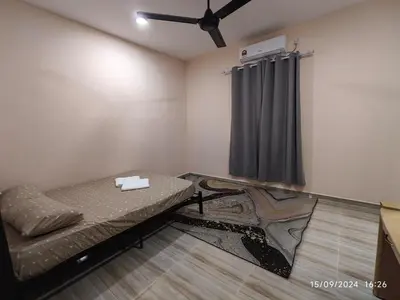 a small room with a bed and a ceiling fan at Syakeel Homestay Bandar Bharu, Parit Buntar & Nibong Tebal in Bandar Baharu