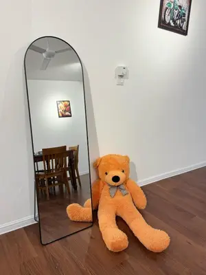 a teddy bear sitting on the floor in front of a mirror at 180View of Keafarm 7-9Pax CoolSummer at Palas Horizon in Tanah Rata