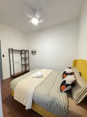 a bedroom with a bed with a ceiling fan at 180View of Keafarm 7-9Pax CoolSummer at Palas Horizon in Tanah Rata