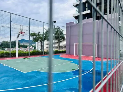 a basketball court in a building with a net at Home Away From Home in Penang in Jelutong
