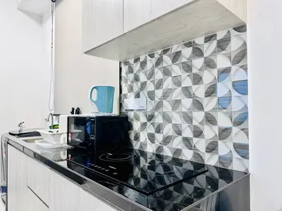 a kitchen with a counter top with a microwave at Home Away From Home in Penang in Jelutong