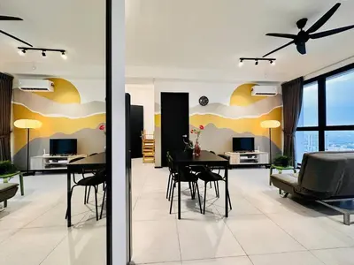 a dining room and living room with a table and chairs at Home Away From Home in Penang in Jelutong