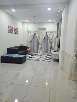 a living room with a black couch and a living room with a couch at Mikayla homestay in Ipoh