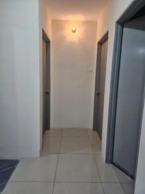 an empty hallway with two doors and a tile floor at Mikayla homestay in Ipoh