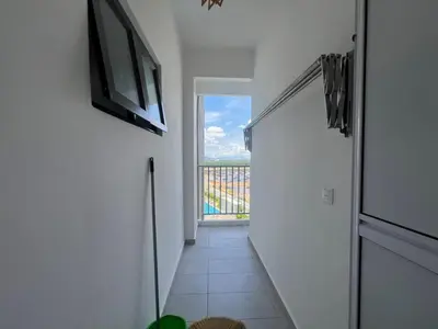 a room with a hallway with a television and a door at Di Aran Residence Penang in Simpang Ampat