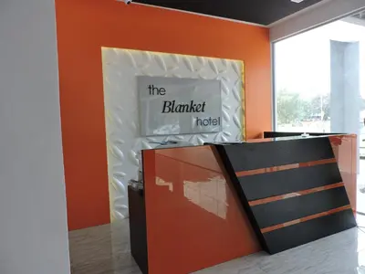 an orange room with a sign on the wall at The Blanket Hotel Seberang Jaya in Perai