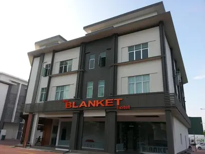 a black and white building with a sign on it at The Blanket Hotel Seberang Jaya in Perai