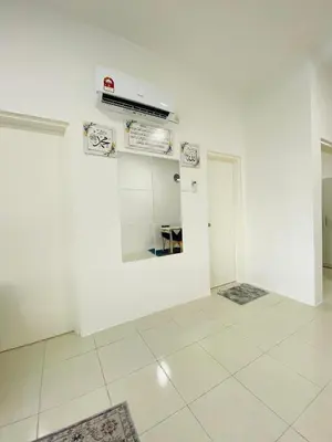 an empty room with white walls and white tile floors at Aiqa homestay in Ipoh