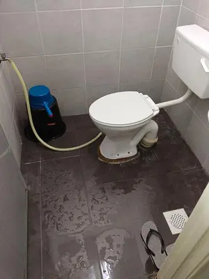 a bathroom with a toilet with a hose at Auni Homestay in Raub