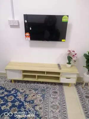 a living room with a television on a wall at Auni Homestay in Raub