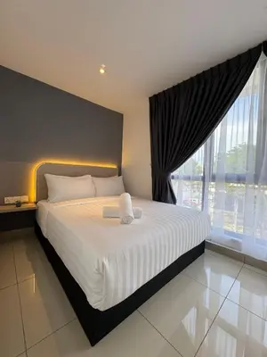 a bedroom with a large bed and a large window at Maca Hotel by Sky Hive in George Town