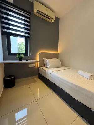 a small bedroom with two beds and a window at Maca Hotel by Sky Hive in George Town