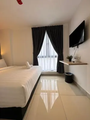 a hotel room with a bed and a large window at Maca Hotel by Sky Hive in George Town