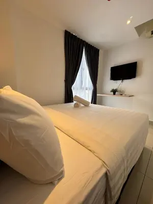 a bedroom with a large white bed and a window at Maca Hotel by Sky Hive in George Town
