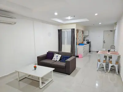 a living room with a couch and a table at Marina Island Apartment, Lumut in Lumut