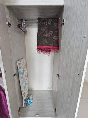 a room with a door with a rug and a mirror at Marina Island Apartment, Lumut in Lumut