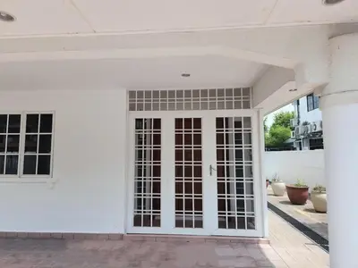 an open door of a white house with glass at 5 min to ipoh town pasir puteh 5br 22pax in Ipoh