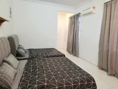 a bedroom with two beds in a room at 5 min to ipoh town pasir puteh 5br 22pax in Ipoh