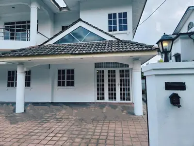a white house with a gate and a brick driveway at 5 min to ipoh town pasir puteh 5br 22pax in Ipoh