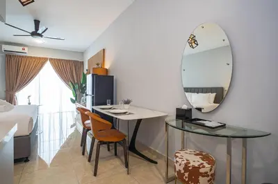 a room with a table and a mirror and a bed at Wyndham Garden Suites IPOH ICC in Ipoh