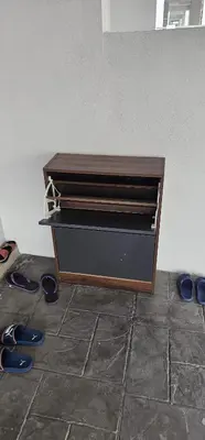 a dresser with two pairs of shoes on the floor at Suria Aman Homestay Semi-D 5 Rooms 5 Bathrooms in Taiping