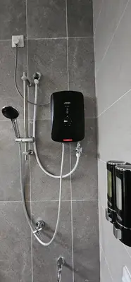 a shower in a bathroom with a box on the wall at Suria Aman Homestay Semi-D 5 Rooms 5 Bathrooms in Taiping