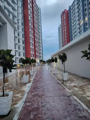 a long corridor with trees and buildings in a city at AzzSpacesAnderson in Ipoh