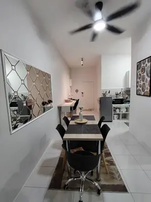 a dining room with a table and a ceiling fan at AzzSpacesAnderson in Ipoh