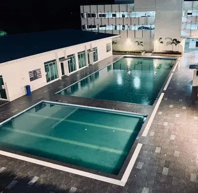 an empty swimming pool in a building at night at AzzSpacesAnderson in Ipoh