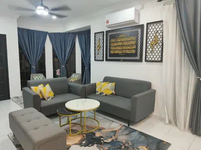 a living room with two couches and a table at Rania Homestay Tasek Gelugor in Padang Chempedak