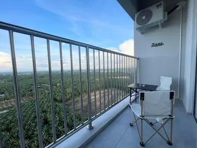 a desk and a chair on a balcony at CozyNest Homestay The venus Sitiawan Sing & Play in Seri Manjung