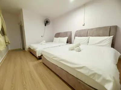 a bedroom with two beds with white sheets at Cozy Stay ALMA NearAEON\u5927\u5c71\u811a\u6e29\u99a8\u6c11\u5bbf in Bukit Mertajam
