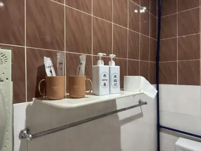 a shelf in a bathroom with toiletries on it at Cozy Stay ALMA NearAEON\u5927\u5c71\u811a\u6e29\u99a8\u6c11\u5bbf in Bukit Mertajam