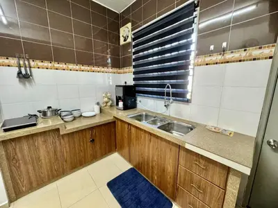 a small kitchen with a sink and a window at Cozy Stay ALMA NearAEON\u5927\u5c71\u811a\u6e29\u99a8\u6c11\u5bbf in Bukit Mertajam