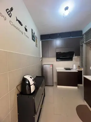 a small kitchen with a toaster sitting on a counter at SweetHome in Ipoh