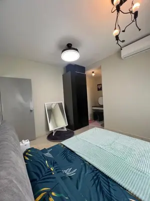 a bedroom with a bed and a television in it at SweetHome in Ipoh