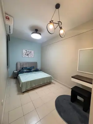 a bedroom with a bed and a flat screen tv at SweetHome in Ipoh