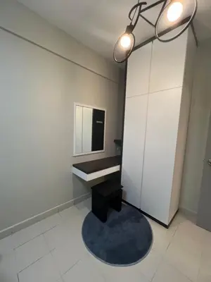 a bathroom with a black stool and a mirror at SweetHome in Ipoh