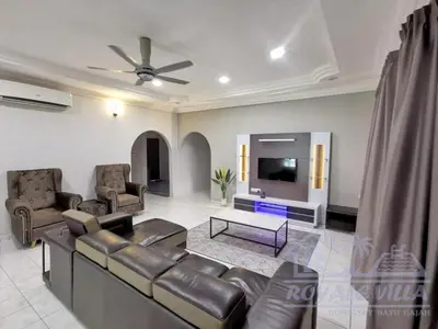 a living room with a couch and a tv at Royale Villa Private Pool Batu Gajah Ipoh Perak in Batu Gajah