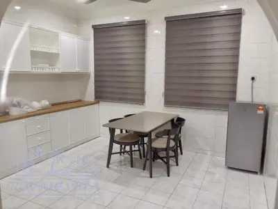 a kitchen with a table and chairs and a refrigerator at Royale Villa Private Pool Batu Gajah Ipoh Perak in Batu Gajah